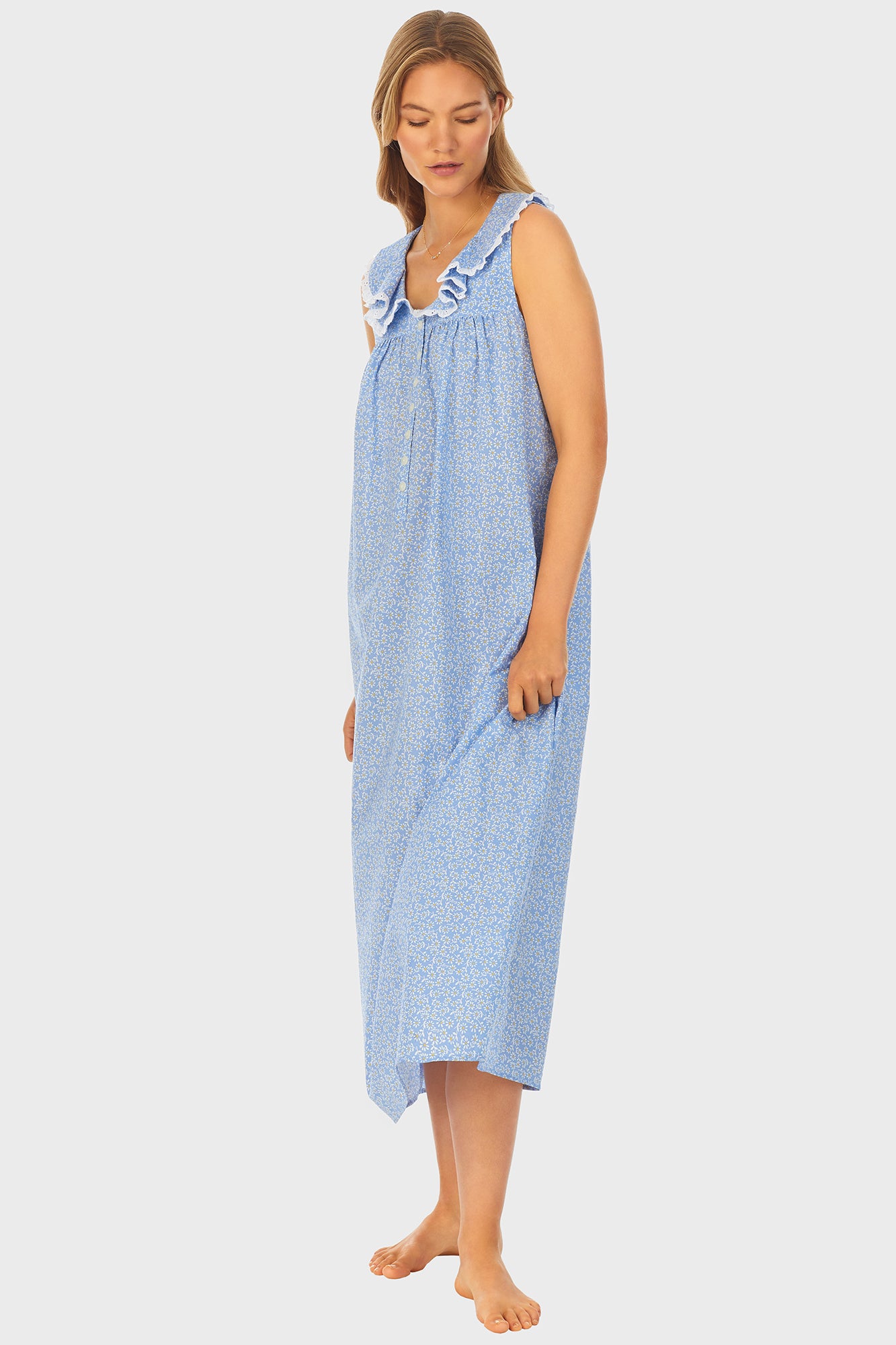 A lady wearing blue long nightgown with a white pattern.