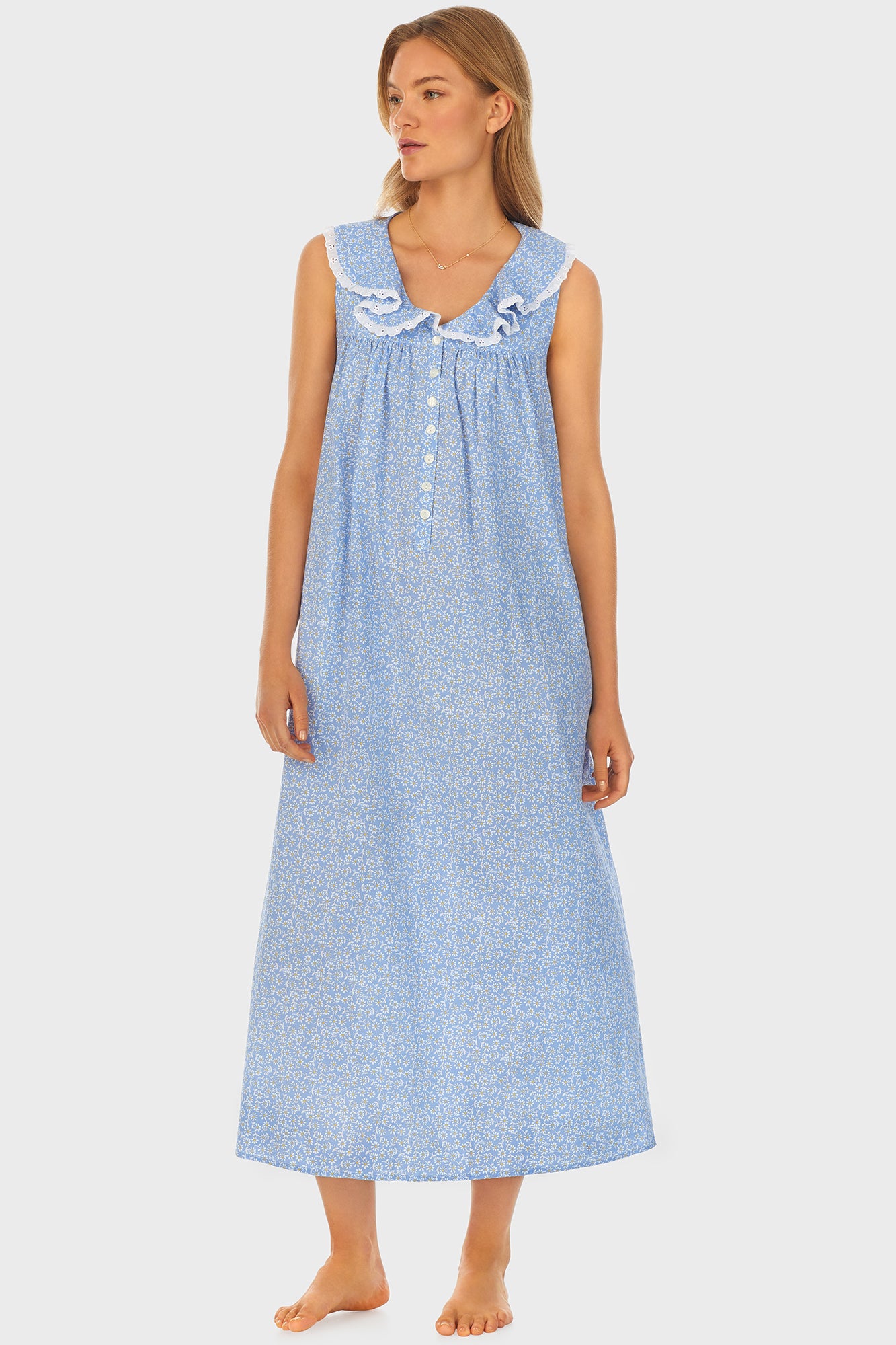 A lady wearing blue long nightgown with a white pattern.