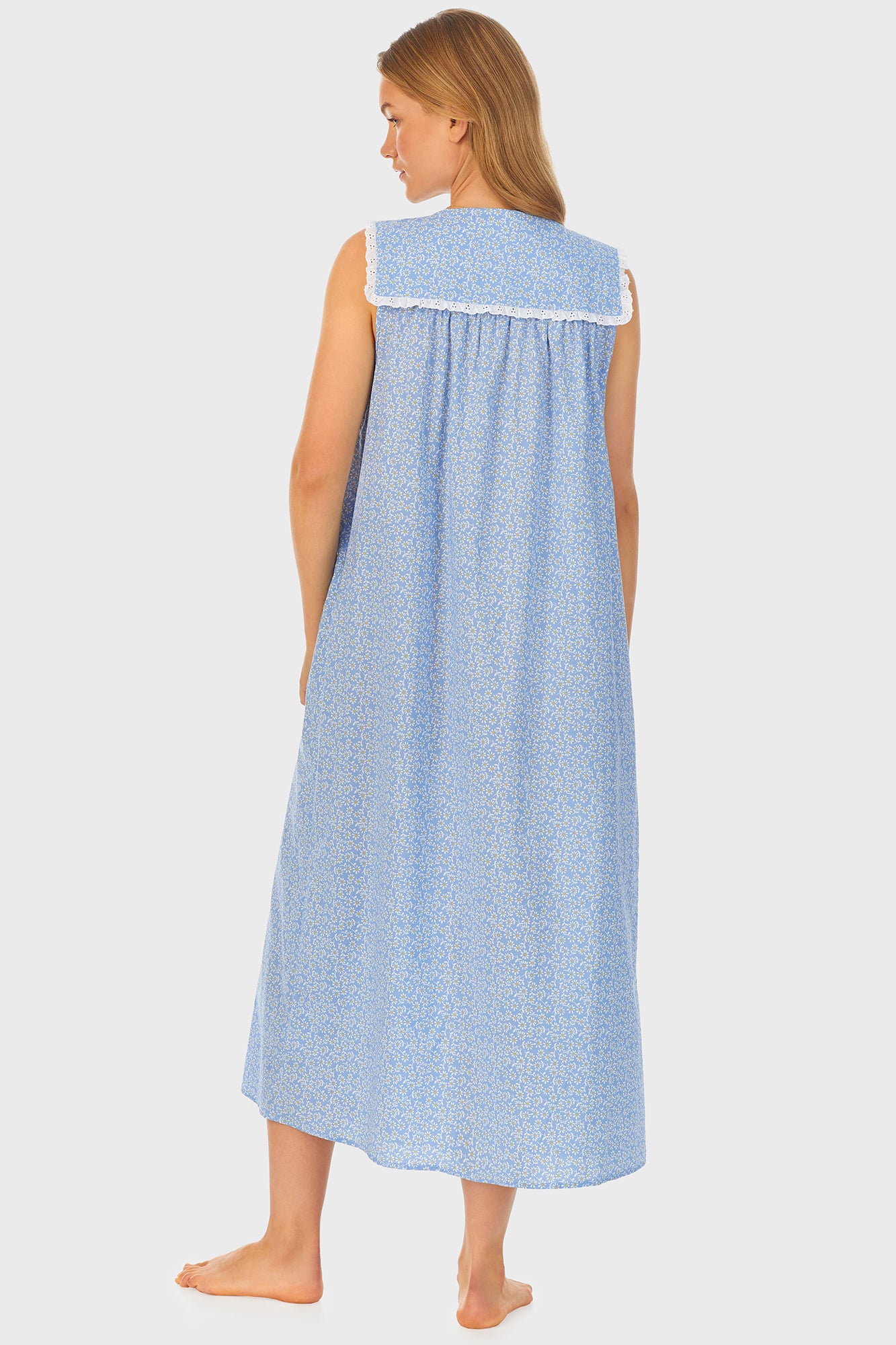 A lady wearing blue long nightgown with a white pattern.