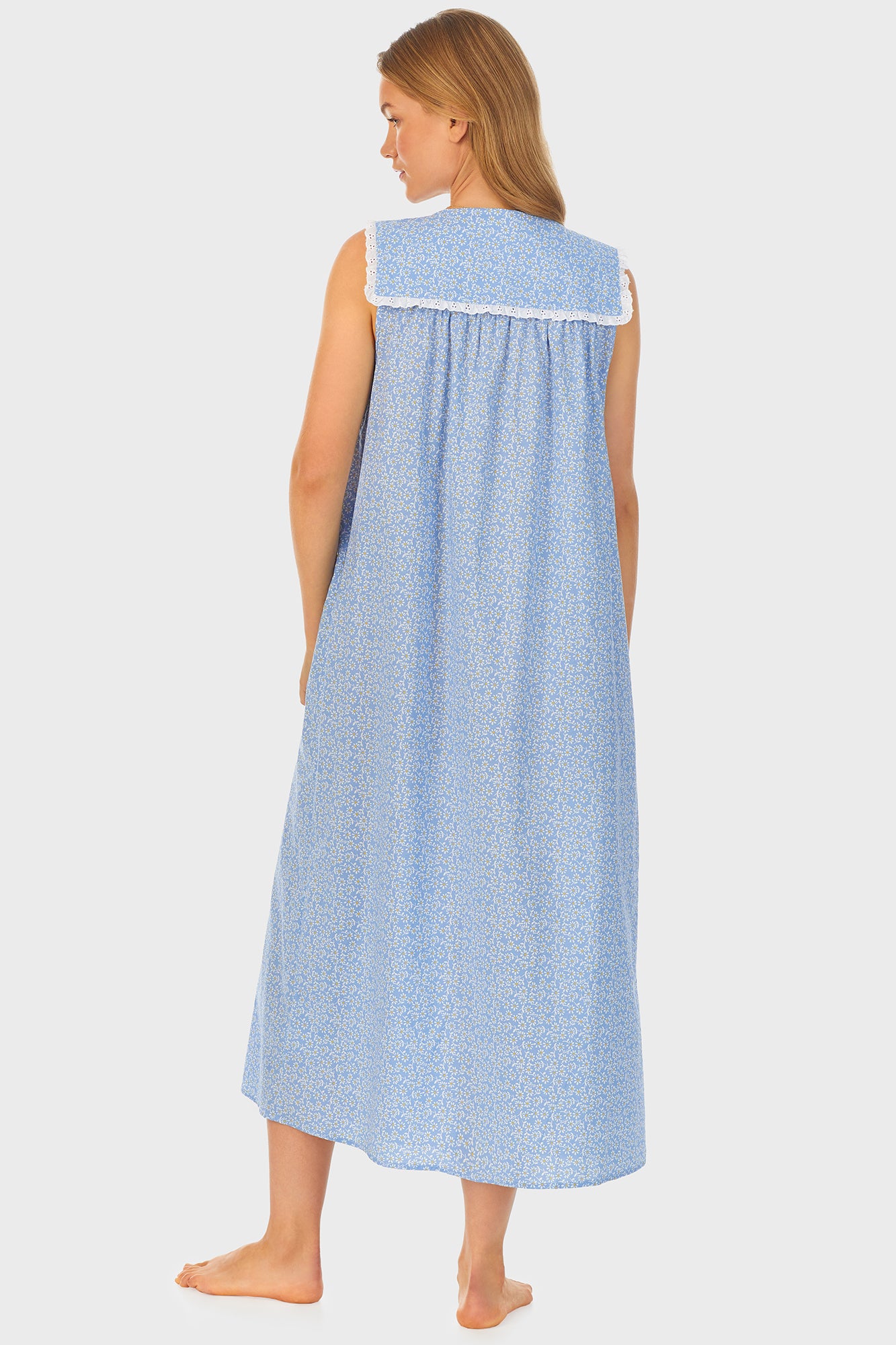  A lady wearing blue long nightgown with a white pattern.