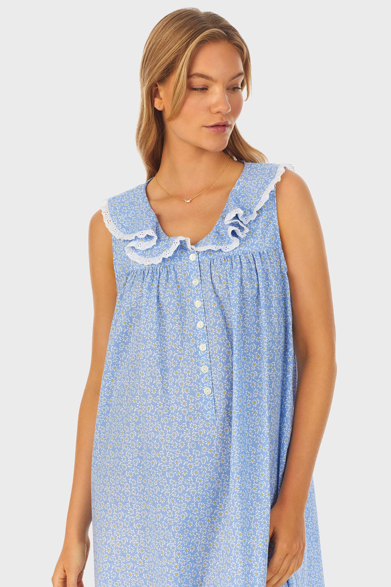 A lady wearing blue long nightgown with a white pattern.