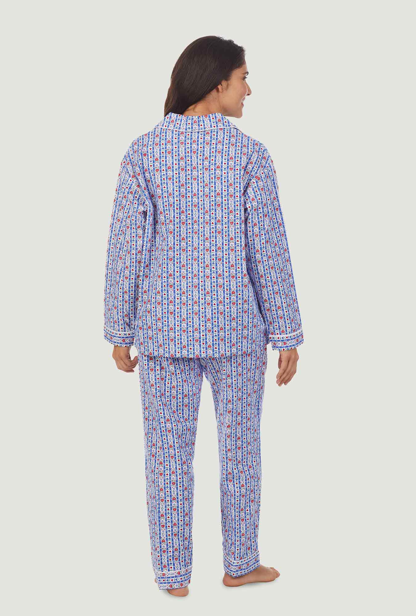 A lady wearing a blue long sleeve flannel pajama with tyrolean stripe pattern.