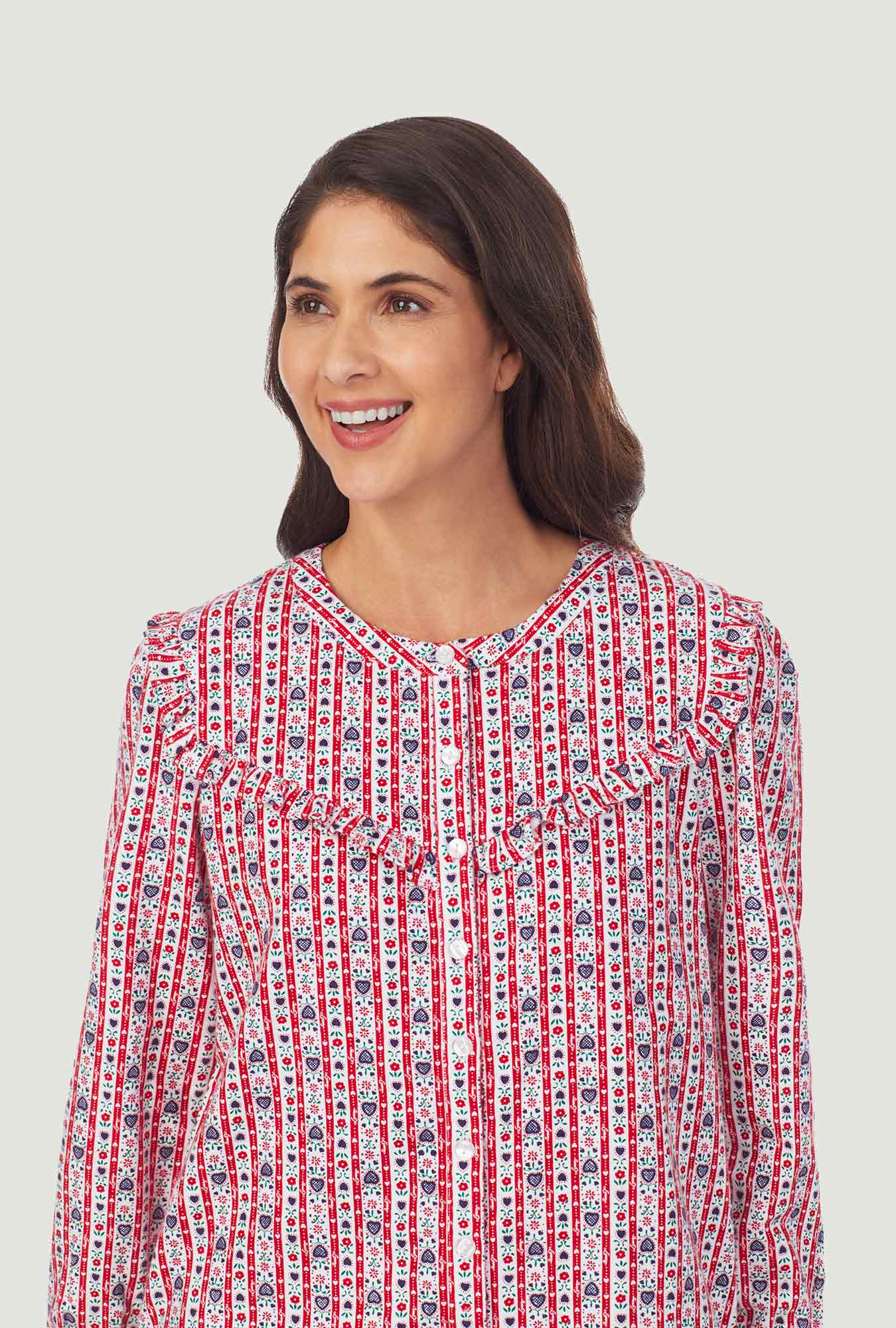 A lady wearing a red tyrolean long sleeve womens nightshirt.