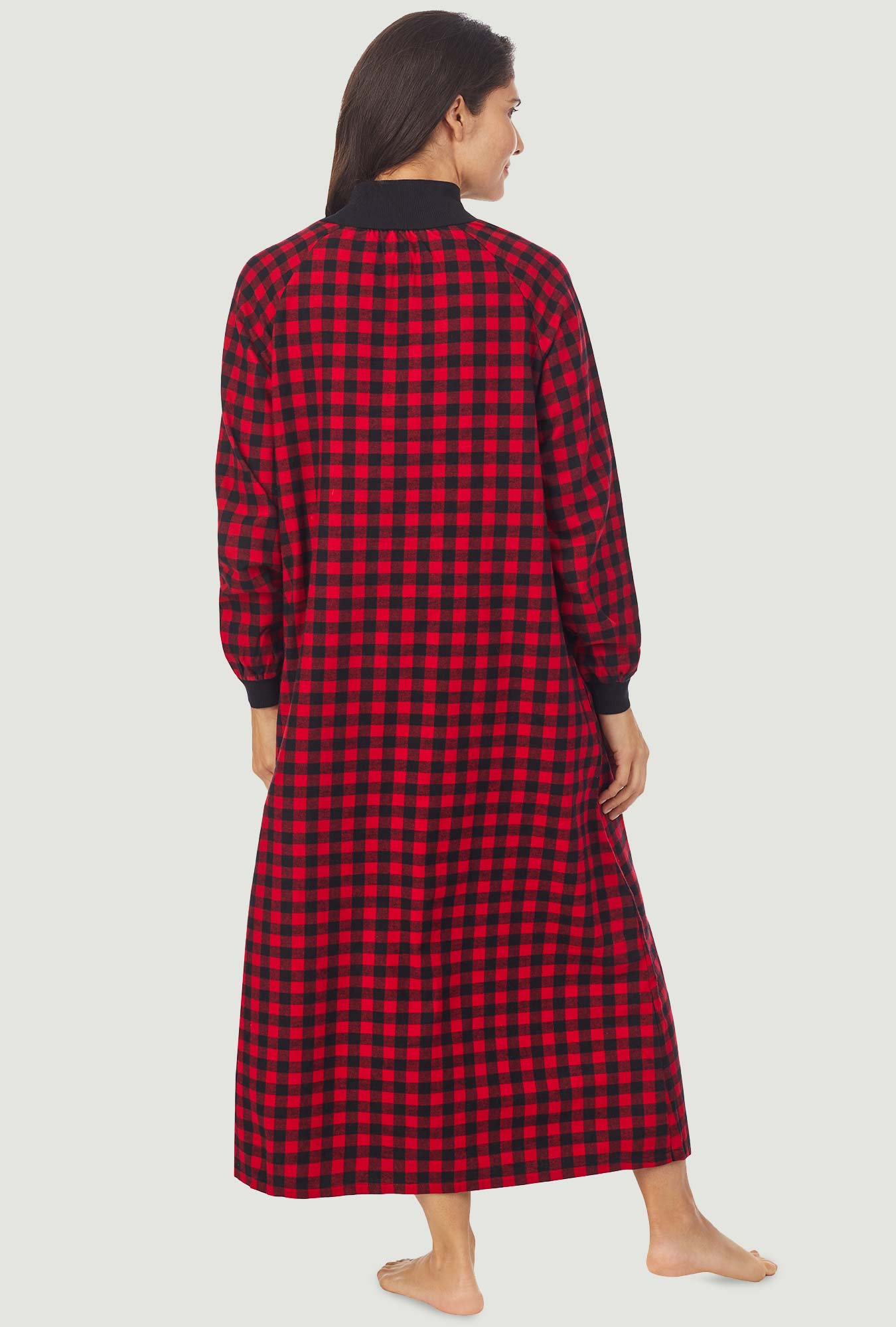 A lady wearing a red buffalo check long sleeve pop over flannel gown.