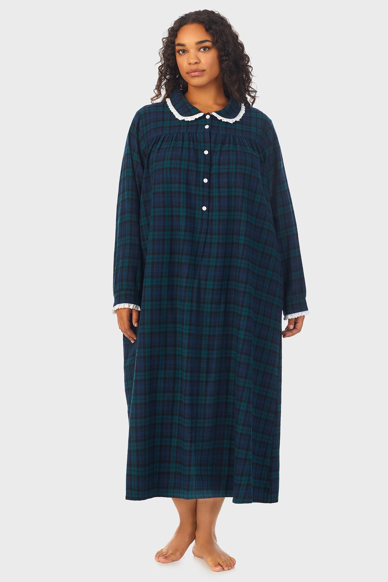 A lady wearing a long sleeve flannel gown plus with black watch peterpan pattern.