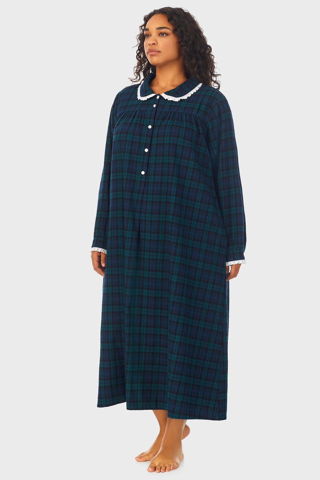  A lady wearing a long sleeve flannel gown plus with black watch peterpan pattern.