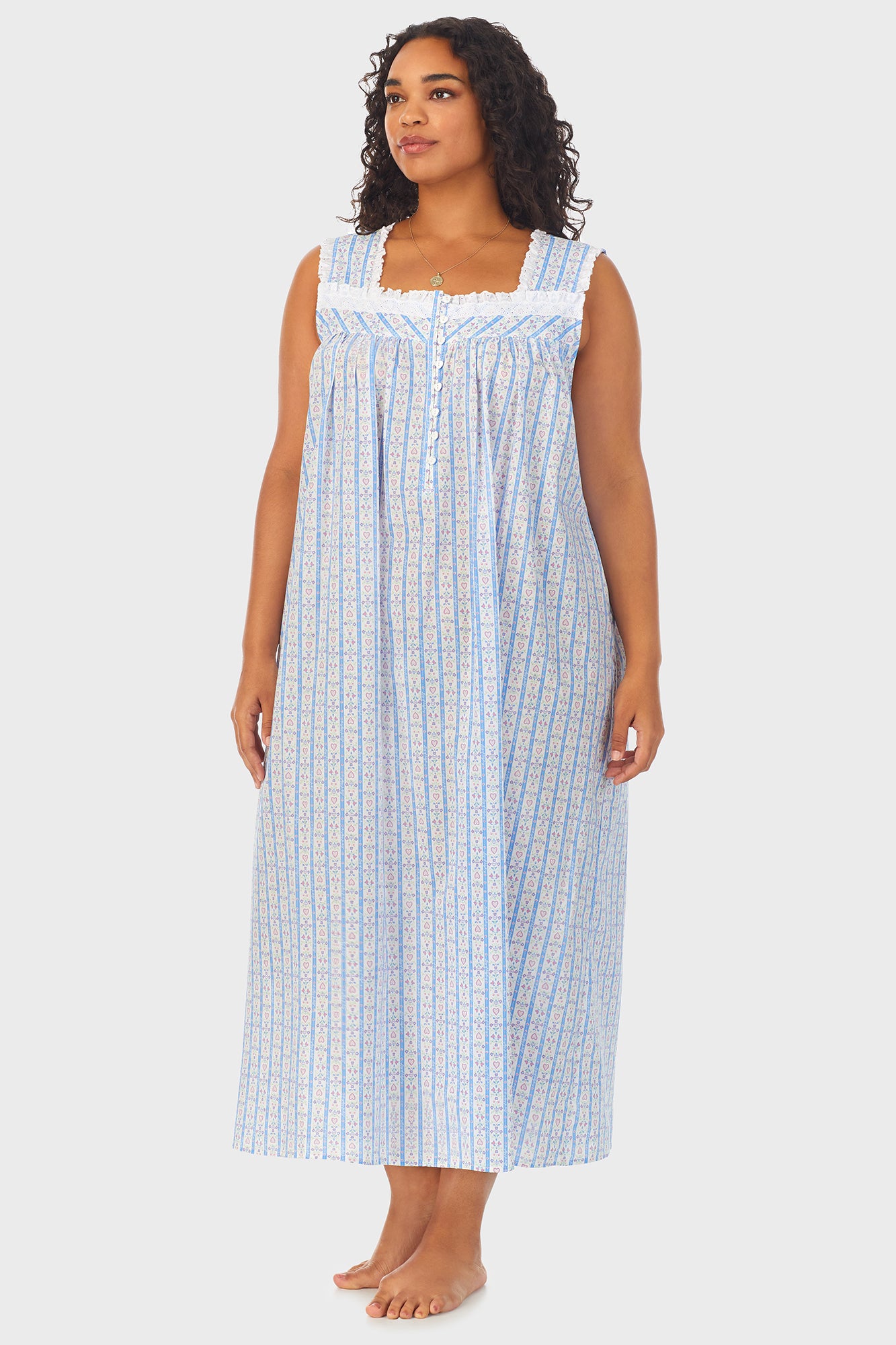 A lady wearing white long nightgown with blue pattern