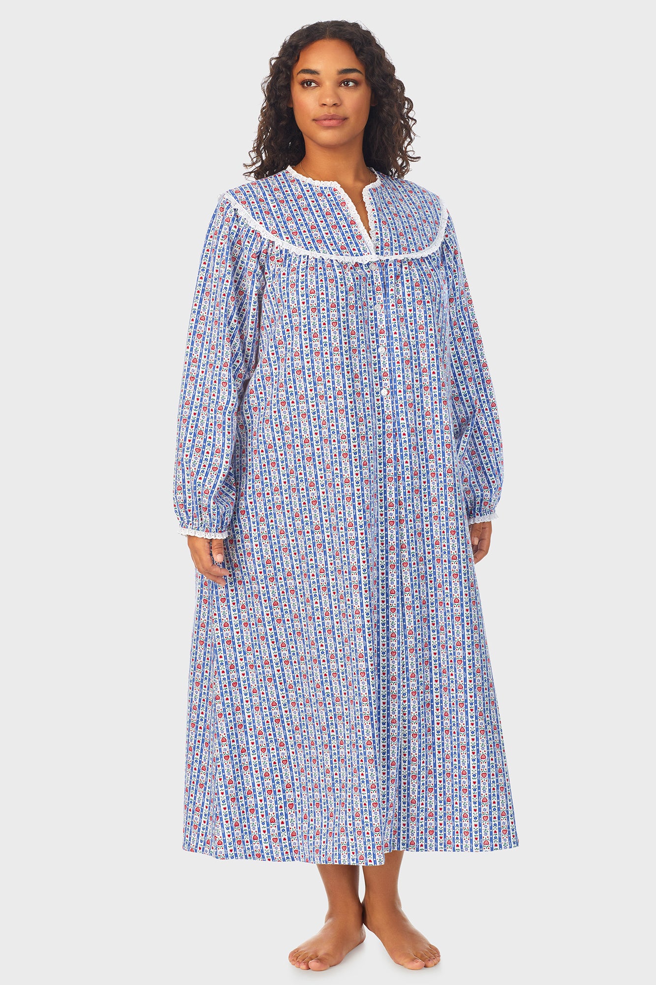 A lady wearing a blue long sleeve flannel nightgown plus with tyrolean stripe pattern.