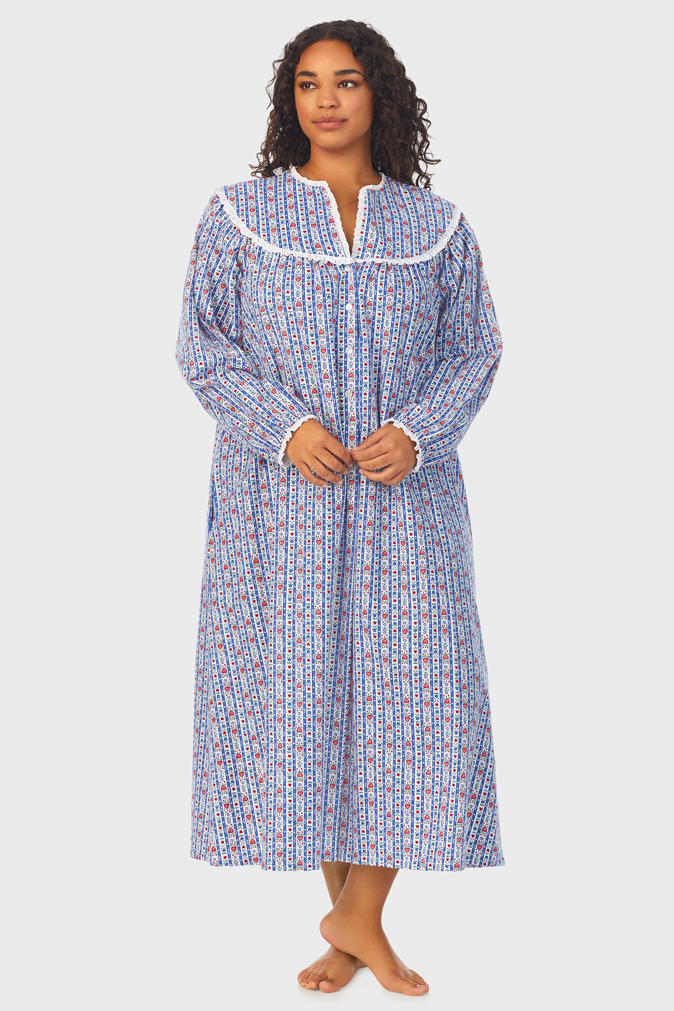 A lady wearing a blue long sleeve flannel nightgown plus with tyrolean stripe pattern.