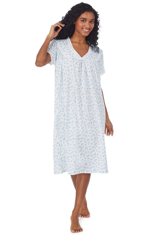 A lady wearing a white short sleeve knit waltz nightgown with tulip pattern.