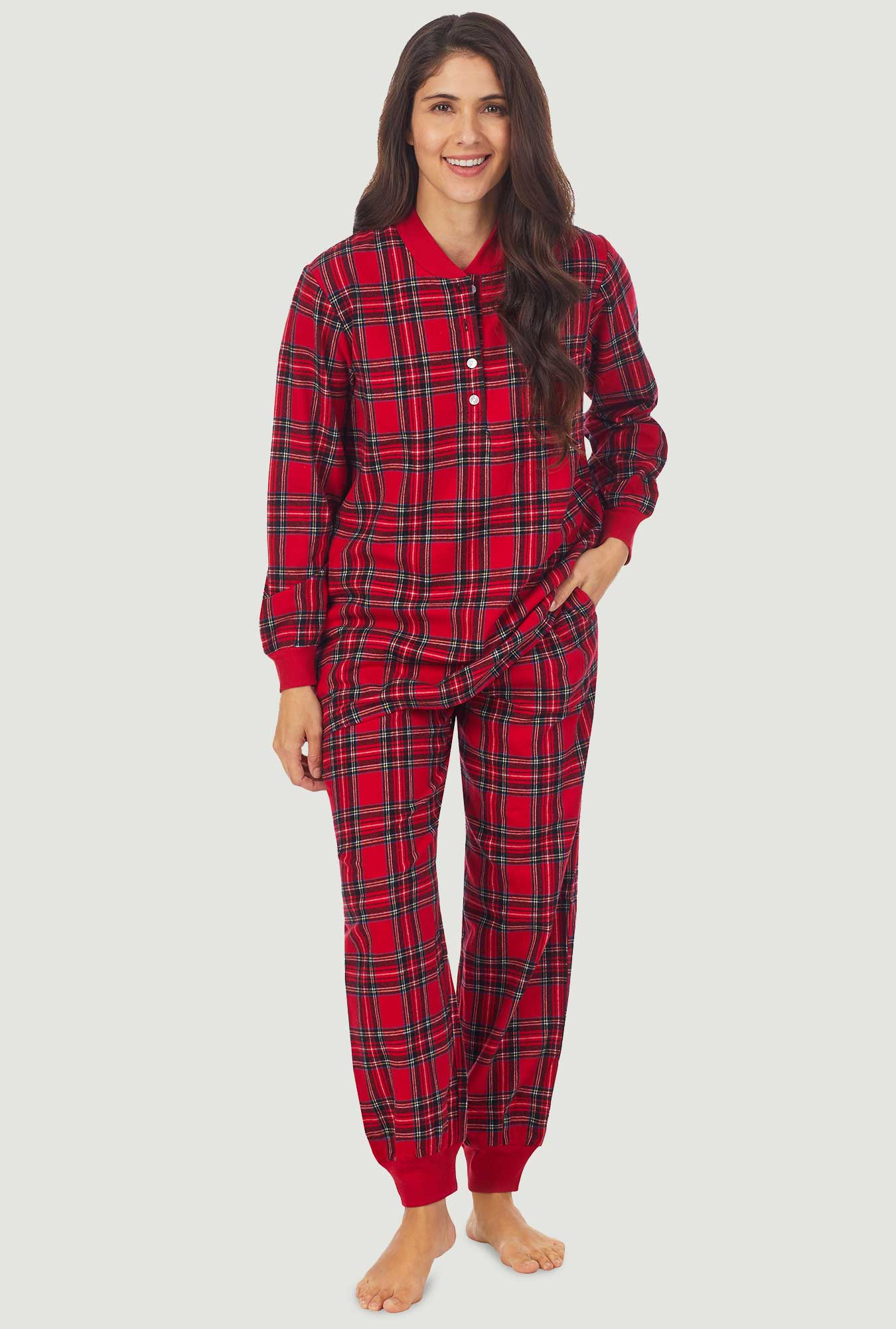 A lady wearing a red tartan long sleeve ski pajama.