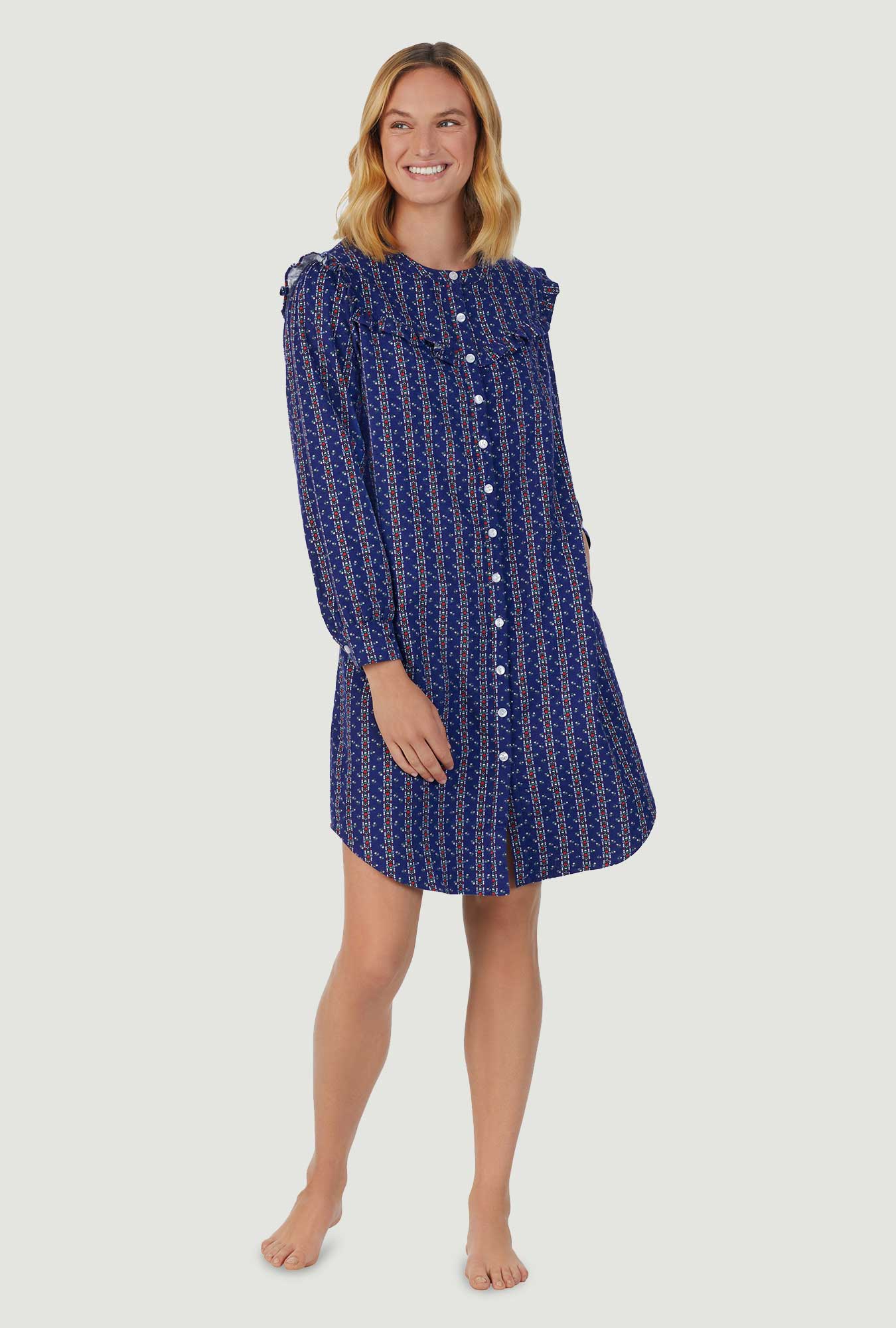 A lady wearing navy long sleeve nightshirt with vintage navy heart stripe print.