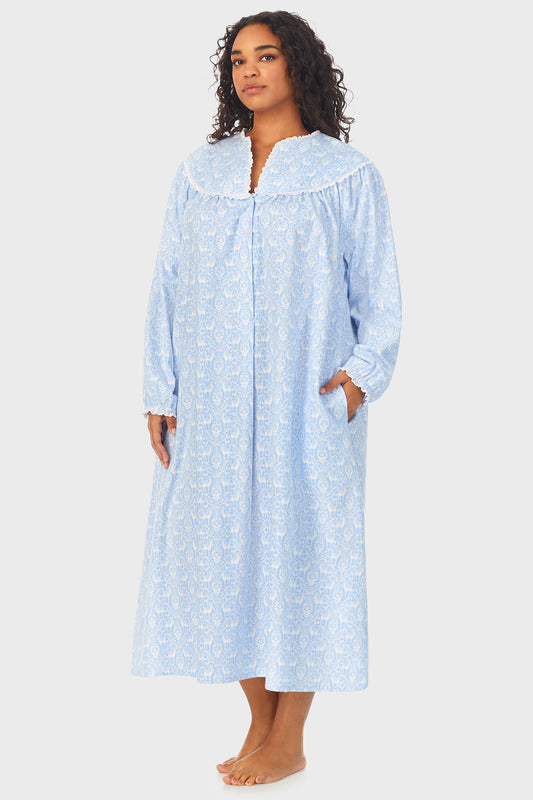 A lady wearing a blue long sleeve flannel gown plus with floral pattern looking Front
